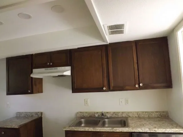 a kitchen with a sink and cabinets