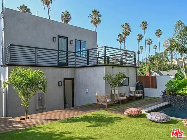 a view of a house with backyard and sitting area