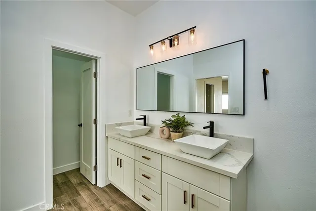 a bathroom with 2 sink and a mirror