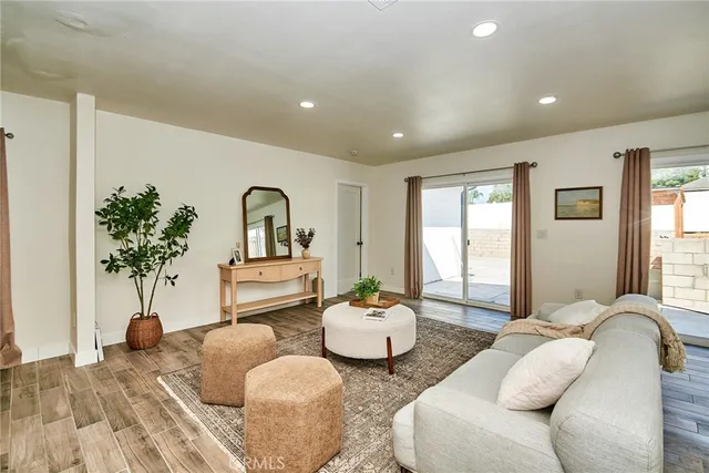 a living room with furniture flowerpot and window
