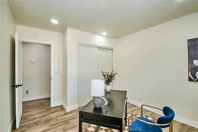 a view of a workspace with furniture and wooden floor