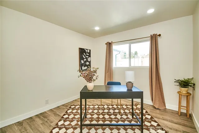 a view of a workspace with furniture and a window