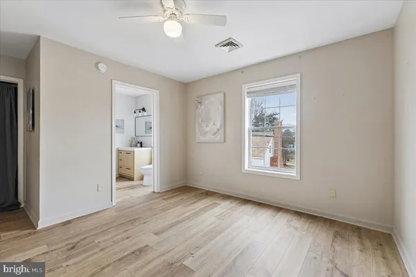 a view of an empty room with a window and a flat screen tv