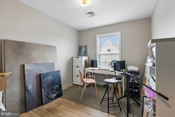 a view of a house with wooden fence