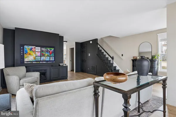 a living room with furniture a fireplace and a window