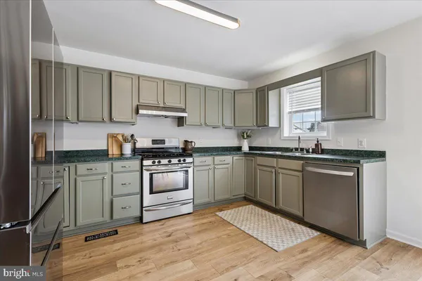 a kitchen with a refrigerator stove and sink