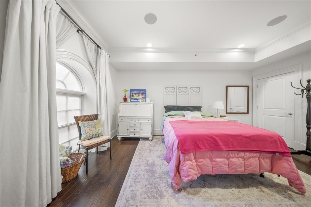 616 East 4th Street, Unit 301 Boston, MA 02127 - Photo 7 of 13 a bedroom with a bed and wooden floor