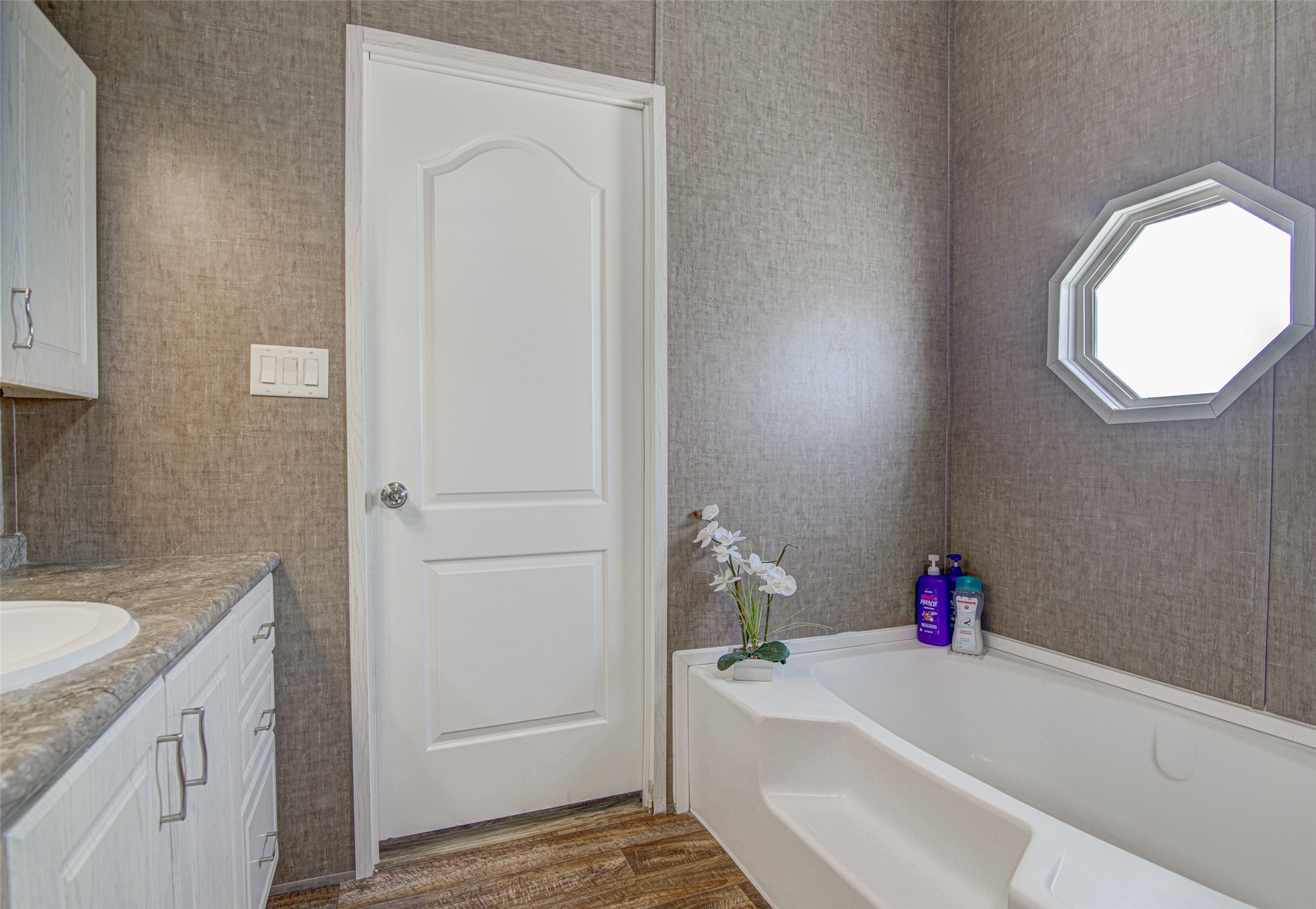 445 Rancho Linda Drive Lockhart, TX 78644 - Photo 19 of 26 Relax in the tub after a long day in this naturally illuminated bathroom.