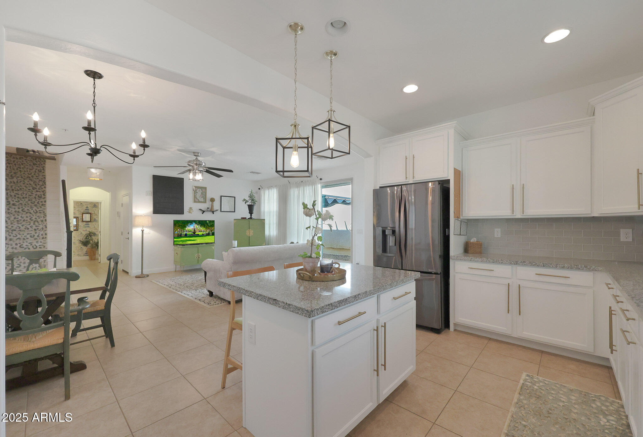 20563 West White Rock Road Buckeye, AZ 85396 - Photo 12 of 44 a kitchen with stainless steel appliances granite countertop a refrigerator a sink a stove a dining table and chairs