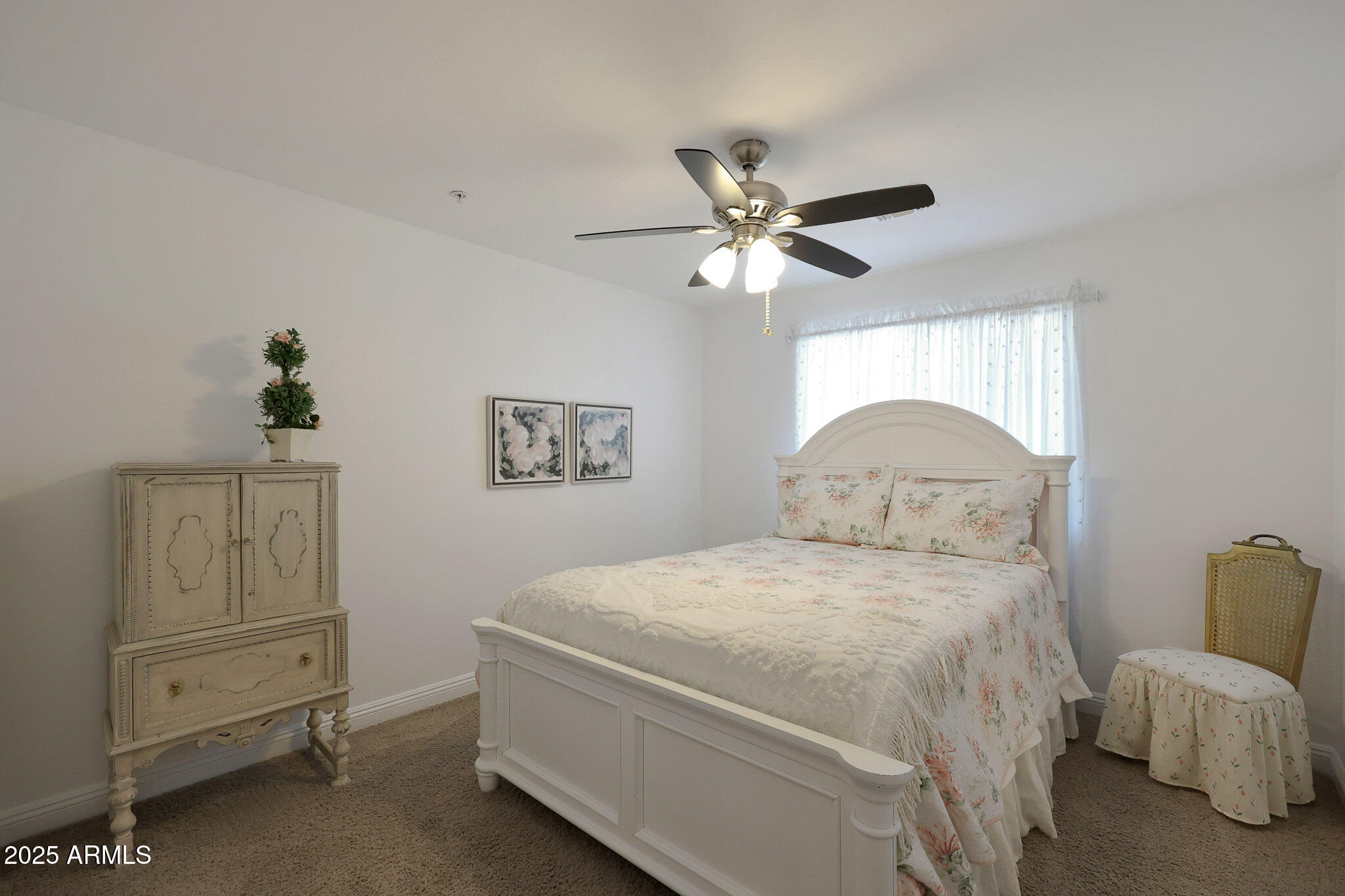 20563 West White Rock Road Buckeye, AZ 85396 - Photo 13 of 44 a bedroom with a bed and a chandelier