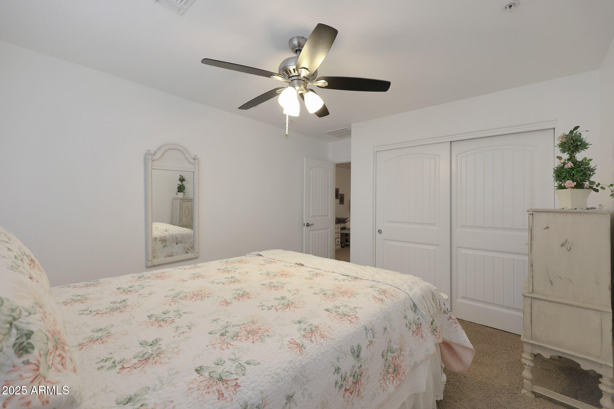 20563 West White Rock Road Buckeye, AZ 85396 - Photo 14 of 44 a bedroom with a bed and a chandelier