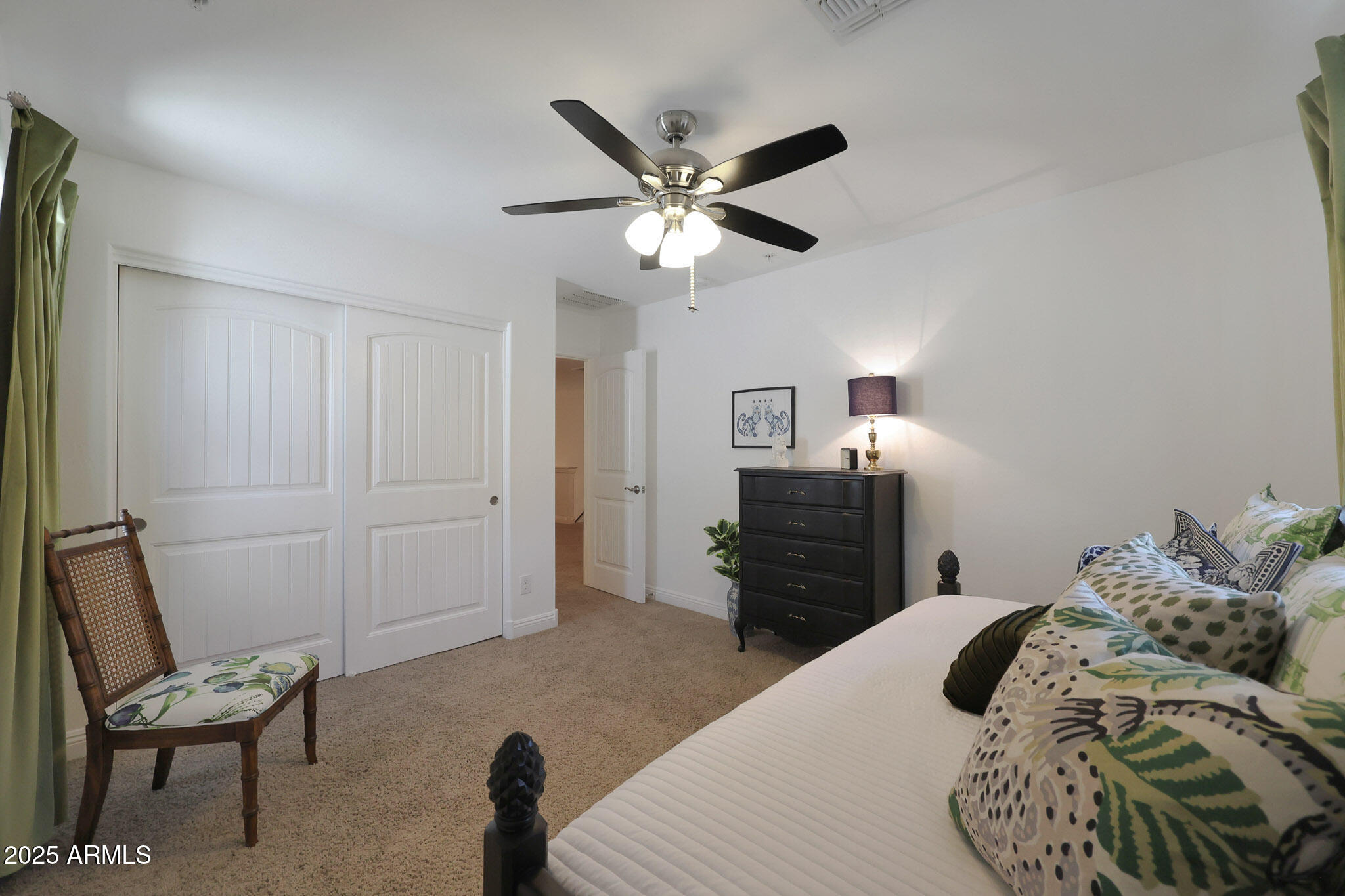 20563 West White Rock Road Buckeye, AZ 85396 - Photo 16 of 44 a bedroom with a bed and a chandelier