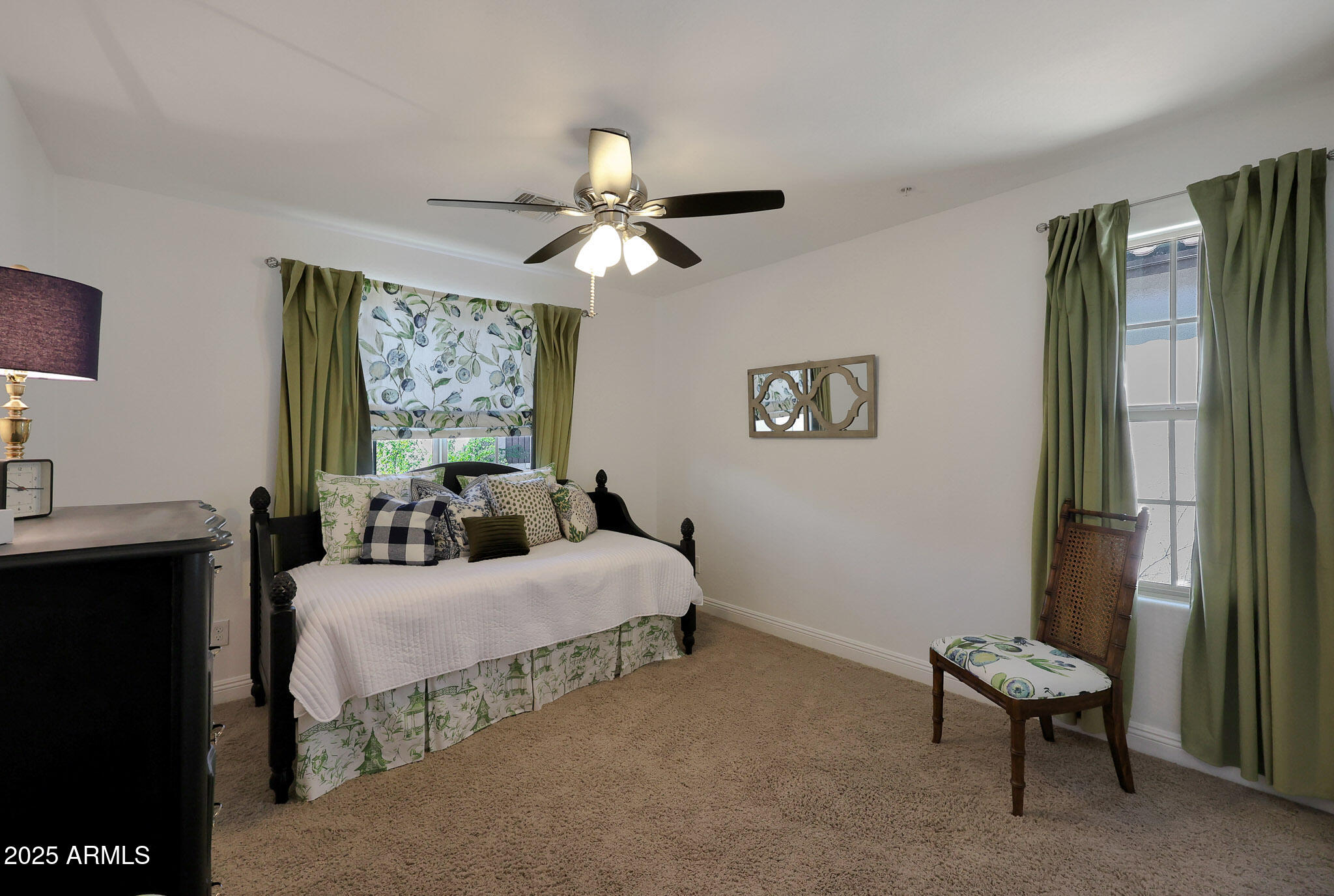 20563 West White Rock Road Buckeye, AZ 85396 - Photo 17 of 44 a bedroom with a bed and a chandelier