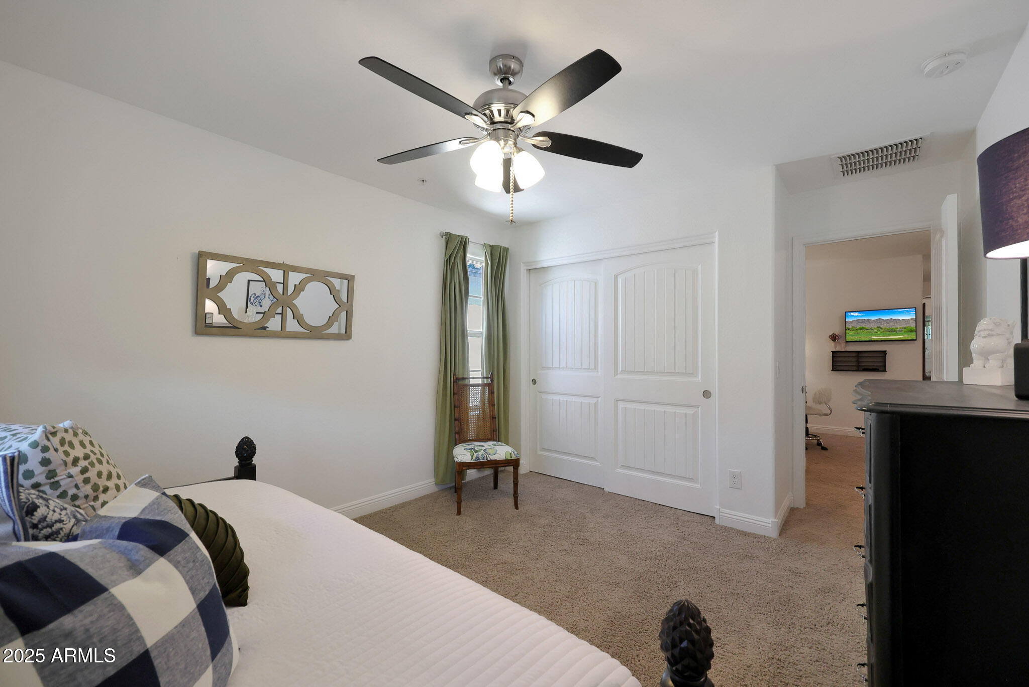 20563 West White Rock Road Buckeye, AZ 85396 - Photo 18 of 44 a bedroom with a bed and a chandelier