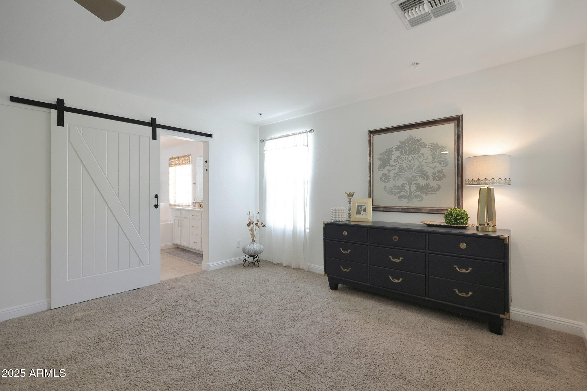 20563 West White Rock Road Buckeye, AZ 85396 - Photo 26 of 44 a room with a dresser and a window
