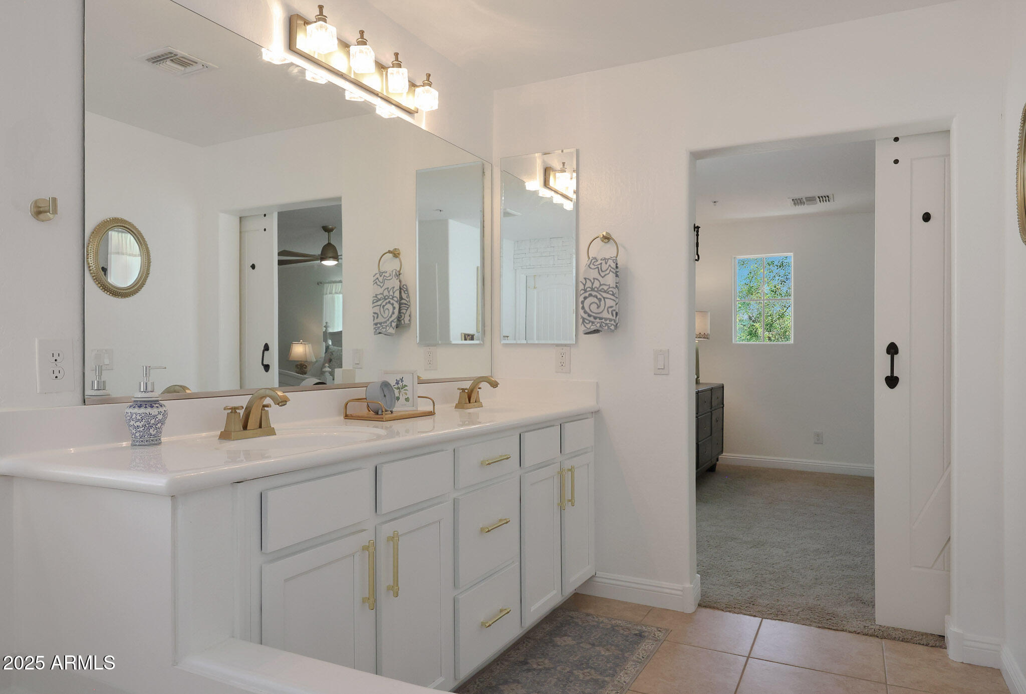 20563 West White Rock Road Buckeye, AZ 85396 - Photo 28 of 44 a bathroom with a double vanity sink and mirror