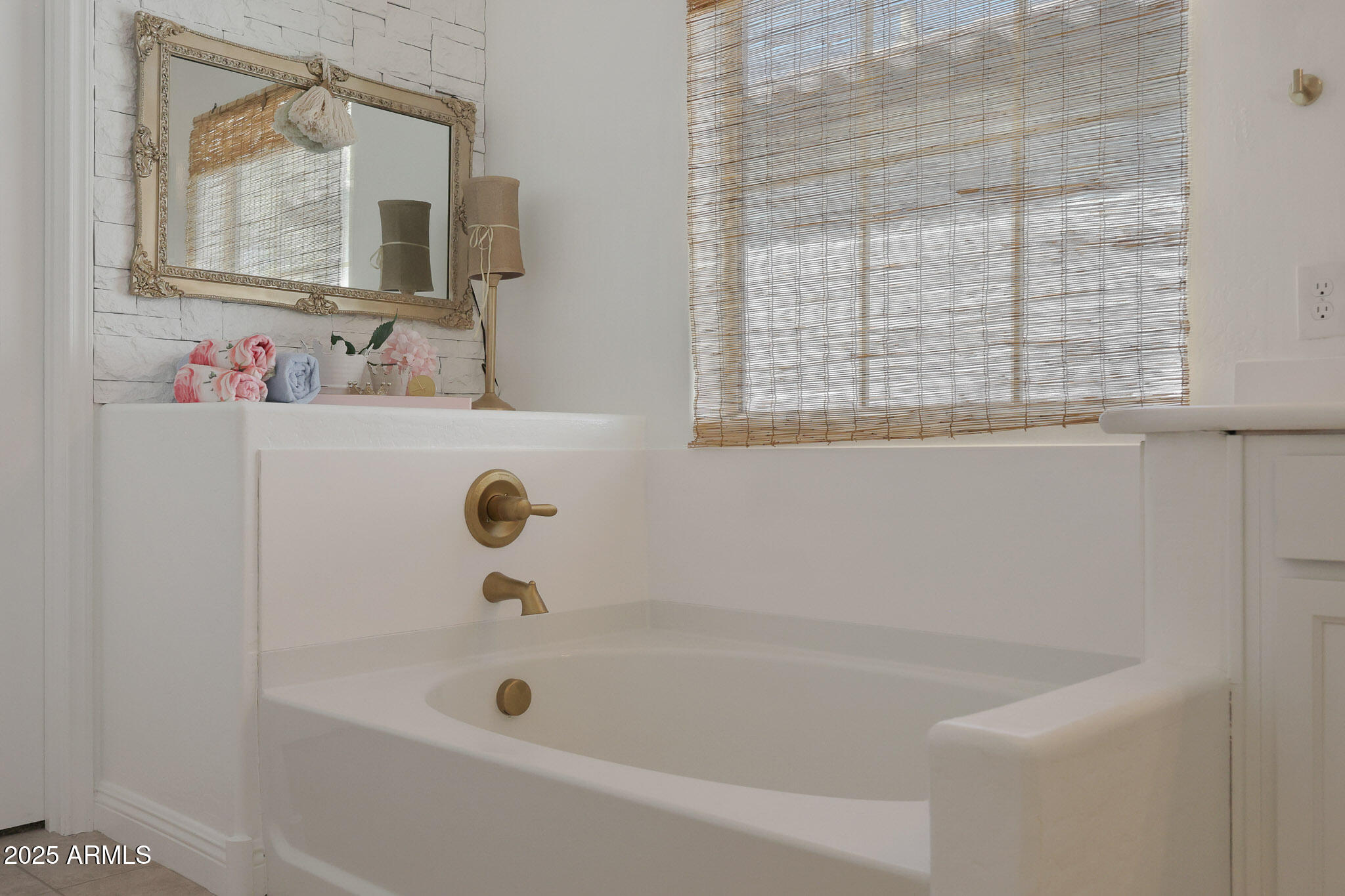 20563 West White Rock Road Buckeye, AZ 85396 - Photo 29 of 44 a bathroom with a tub sink and mirror