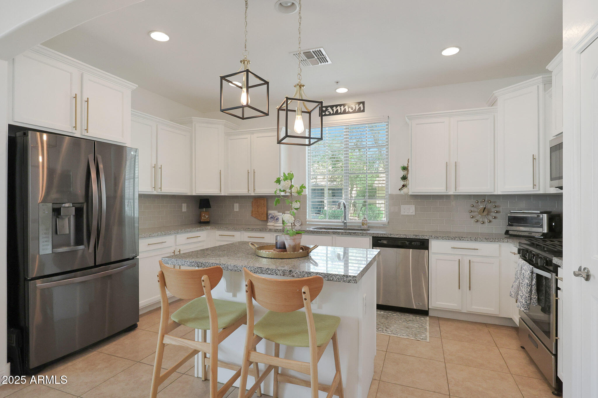 20563 West White Rock Road Buckeye, AZ 85396 - Photo 10 of 44 a kitchen with refrigerator a stove a sink and white cabinets