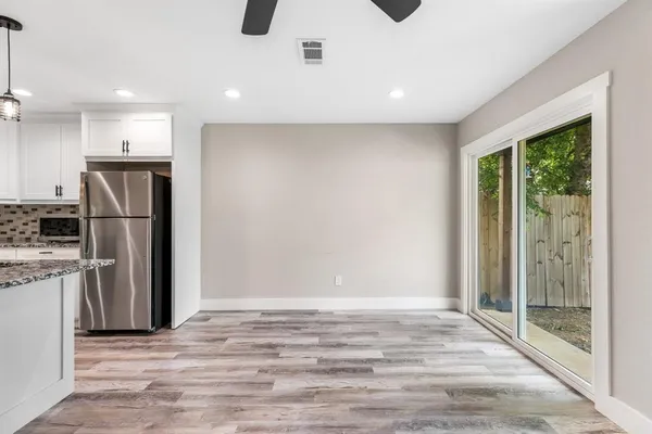 a view of a kitchen with a sink and a refrigerator