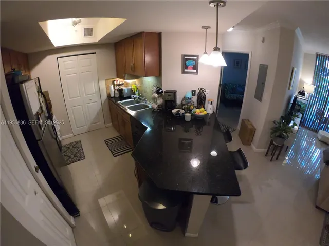 a very nice looking dining room with a chair a fireplace and a flat screen tv