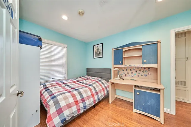 a bedroom with a bed and a dresser