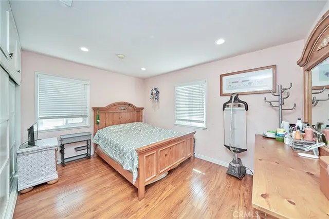 a bedroom with a bed and wooden floor