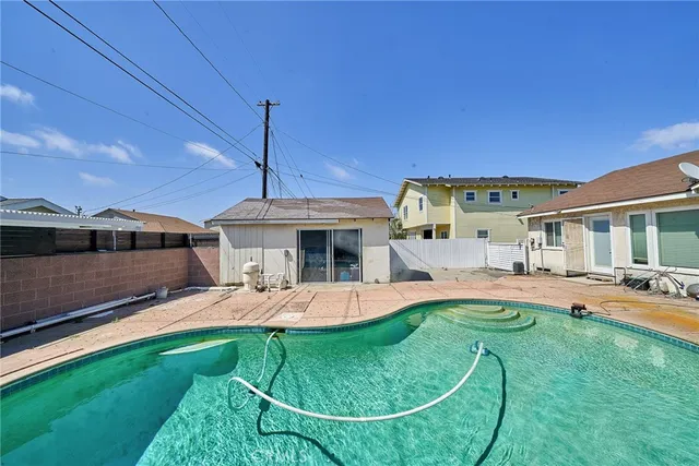 a view of a house with swimming pool and porch