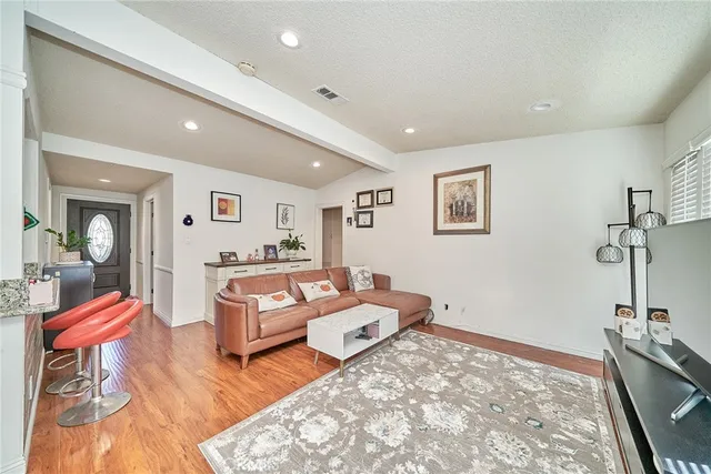 a living room with furniture and wooden floor