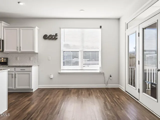 a dining room with furniture and wooden floor