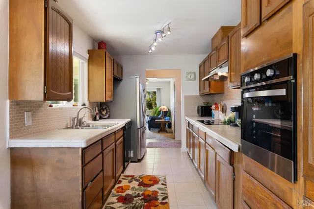 a kitchen with refrigerator cabinets and a sink