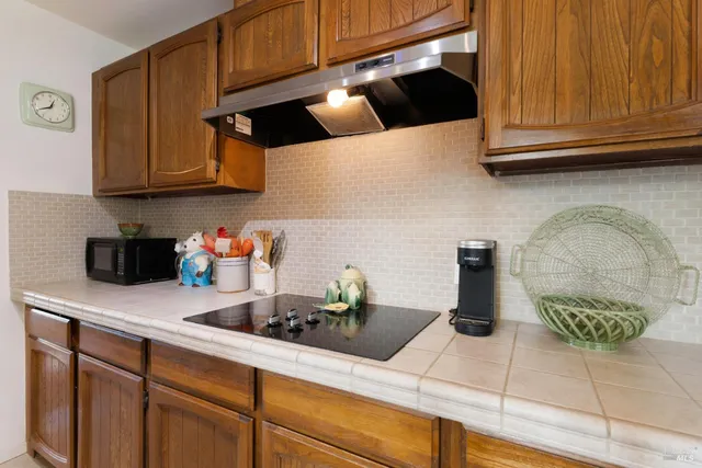 a kitchen with granite countertop cabinets and stainless steel appliances