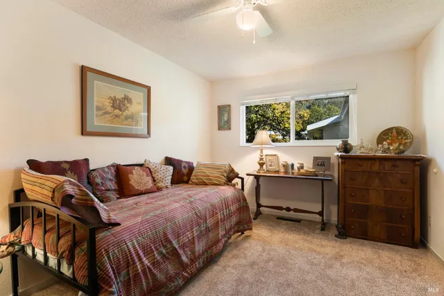 a bedroom with a bed and a desk