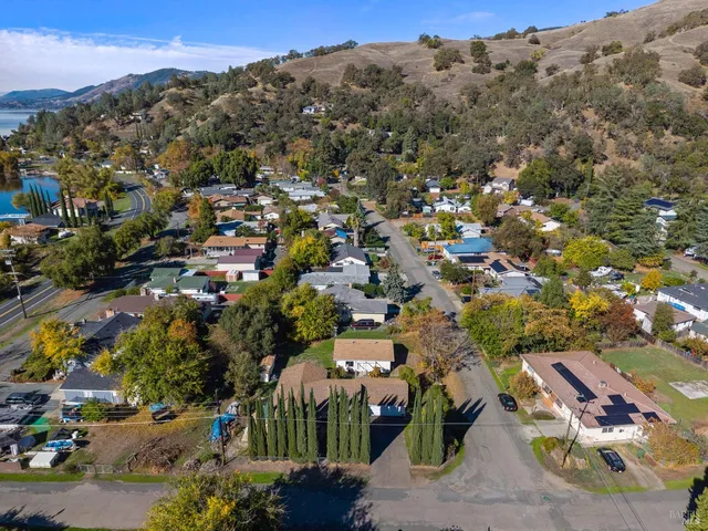 an aerial view of a house with a mountain