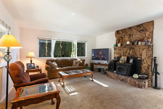 a living room with furniture and large windows