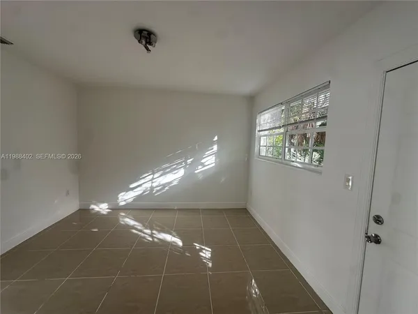 a view of a livingroom with hardwood floor and window
