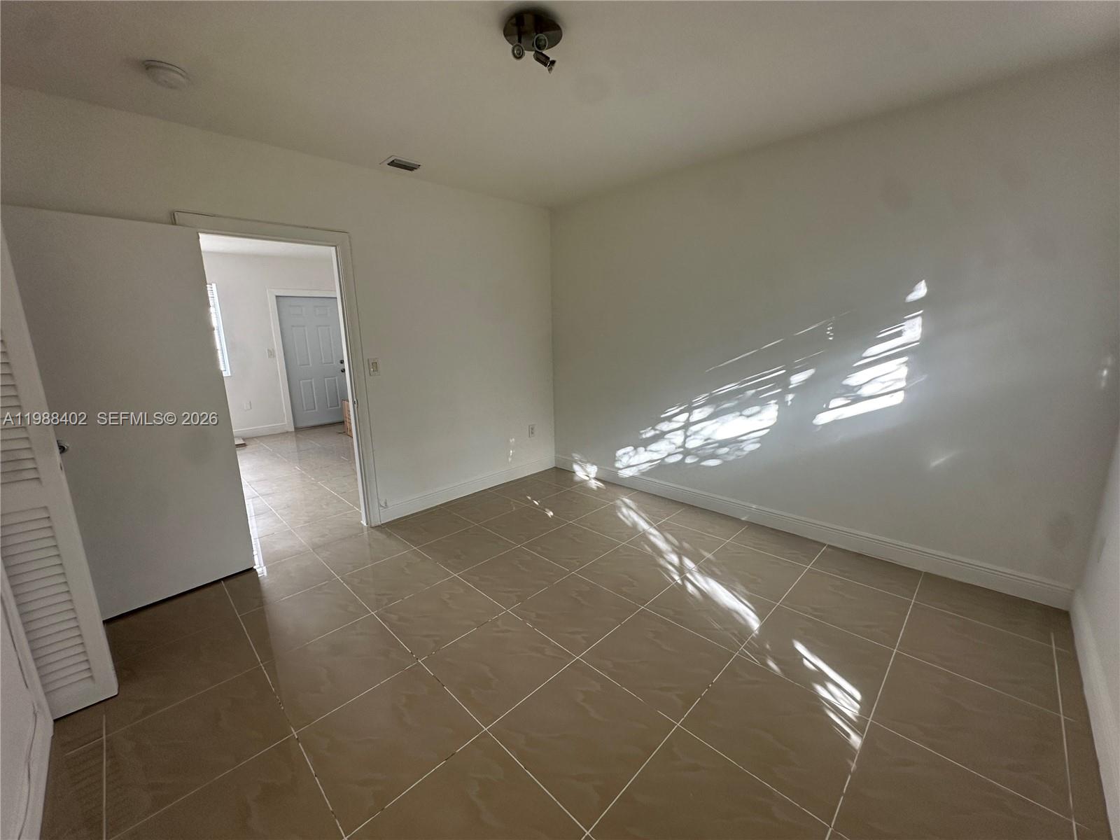 740 84th Street, Unit 3 Miami Beach, FL 33141 - Photo 6 of 12 a view of a livingroom with hardwood floor and window