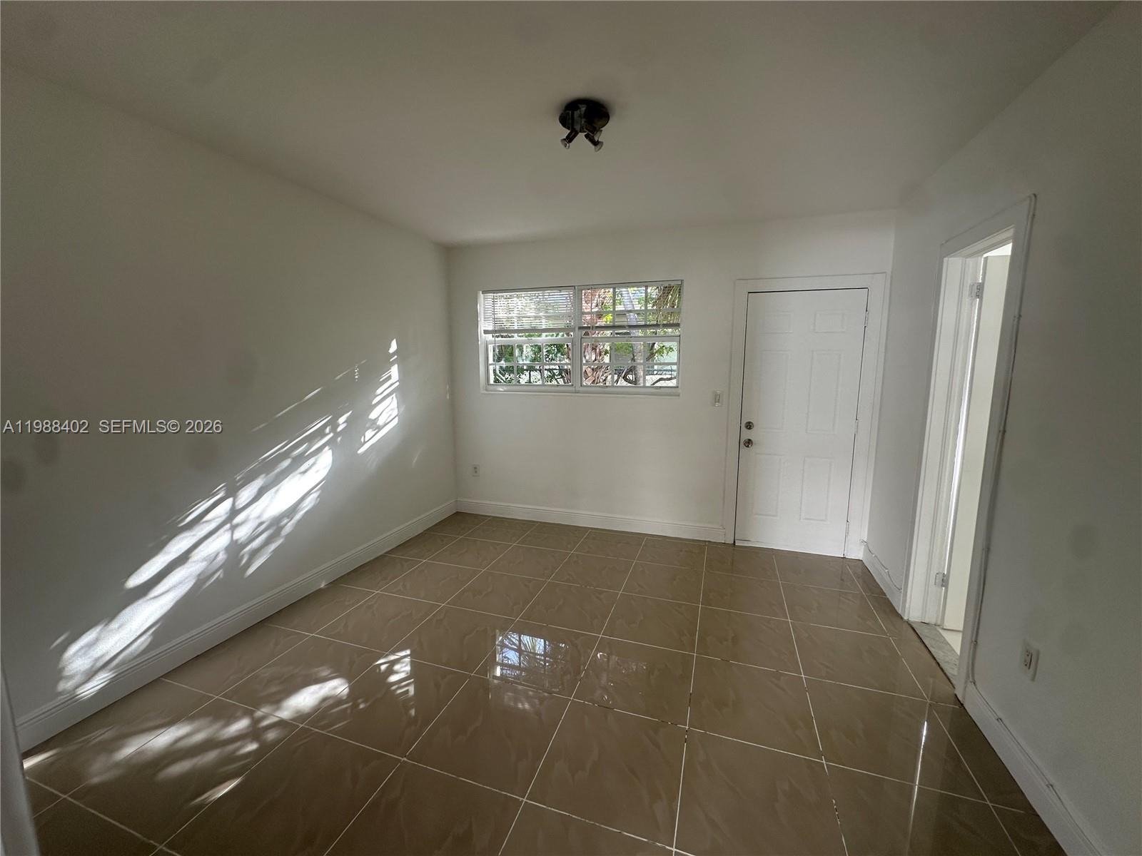 740 84th Street, Unit 3 Miami Beach, FL 33141 - Photo 7 of 12 a view of an empty room and window