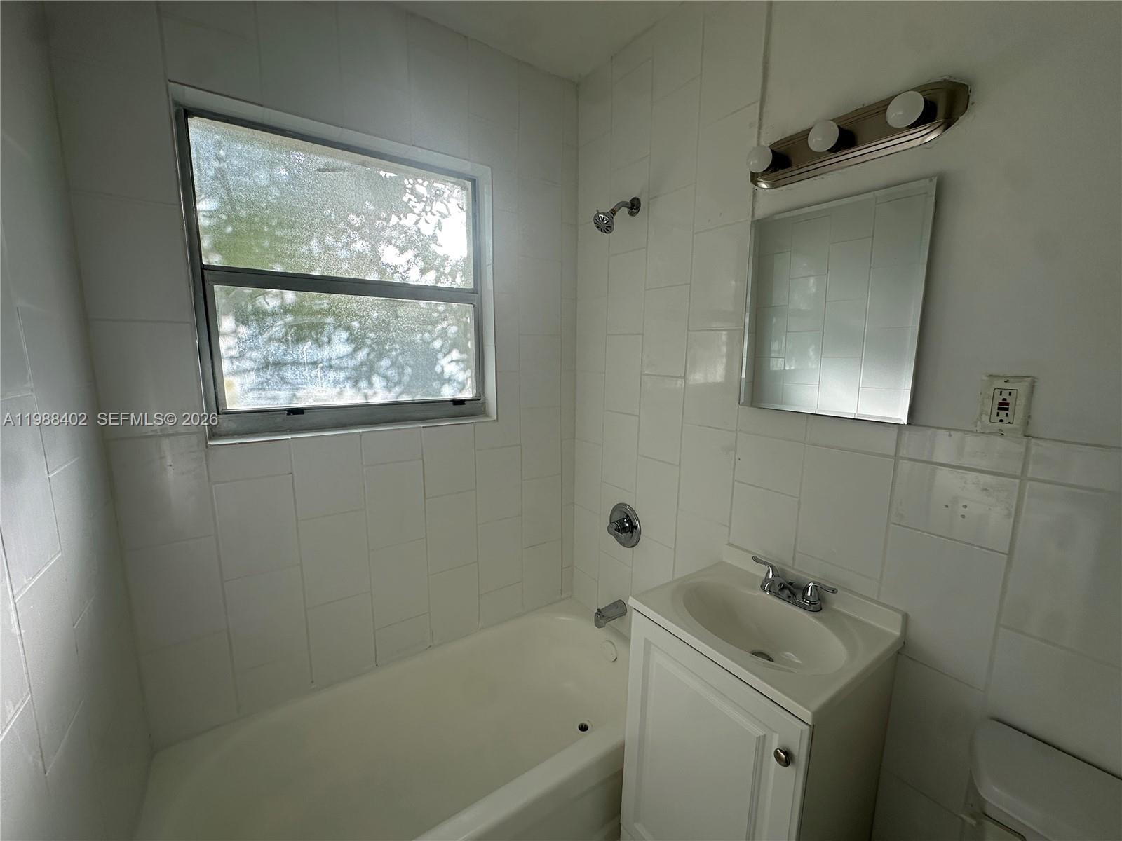 740 84th Street, Unit 3 Miami Beach, FL 33141 - Photo 10 of 12 a bathroom with a sink toilet and tub