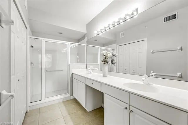 a bathroom with a shower sink and mirror