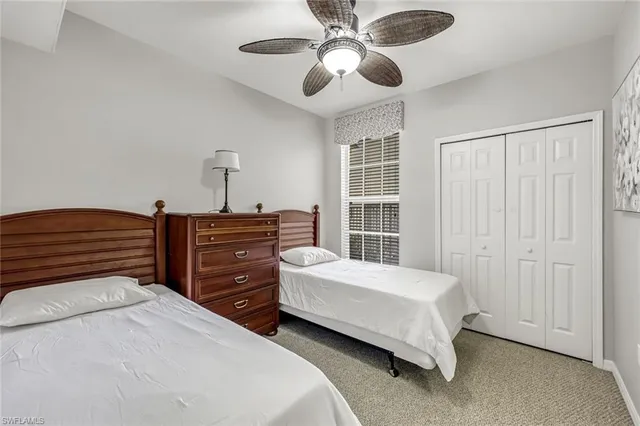 a bedroom with a bed and a ceiling fan