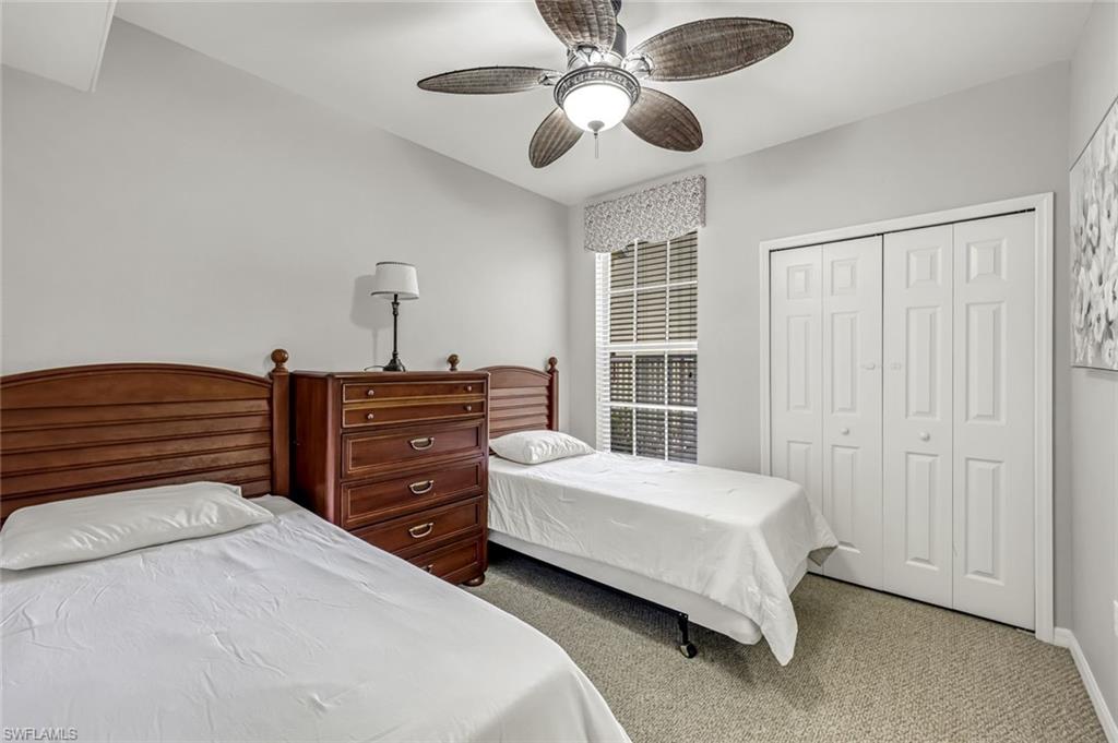 1345 Henley Street, Unit 706 Naples, FL 34105 - Photo 13 of 20 a bedroom with a bed and a ceiling fan
