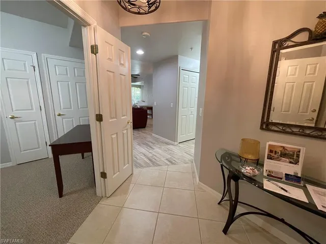 a view of a hallway with couch and mirror