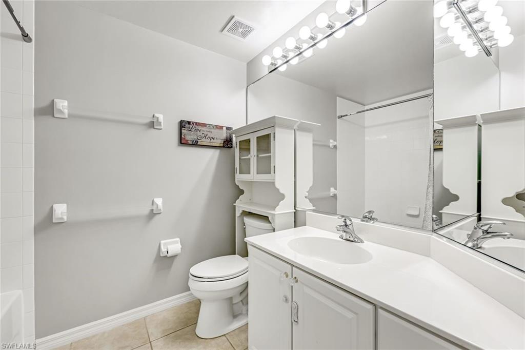 1345 Henley Street, Unit 706 Naples, FL 34105 - Photo 16 of 20 a bathroom with a sink toilet and a mirror