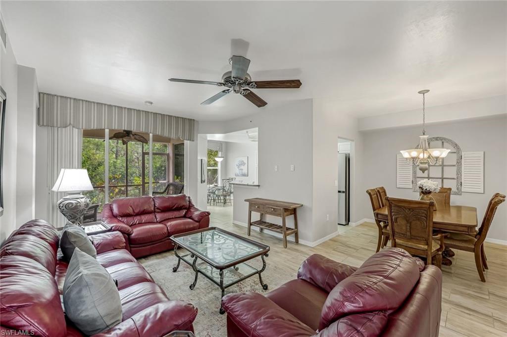 1345 Henley Street, Unit 706 Naples, FL 34105 - Photo 3 of 20 a living room with furniture ceiling fan and a window