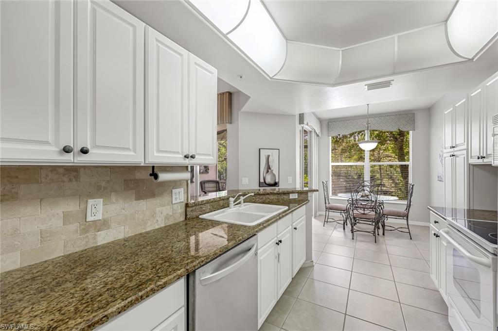 1345 Henley Street, Unit 706 Naples, FL 34105 - Photo 6 of 20 a kitchen with a sink and cabinets