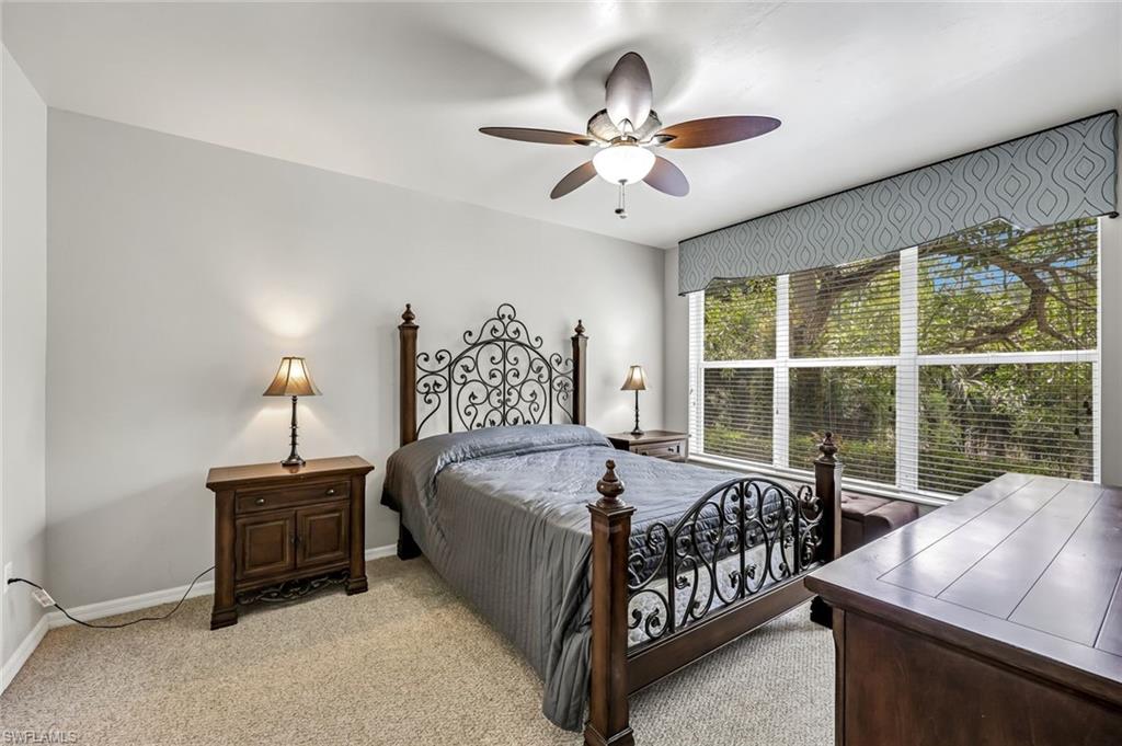 1345 Henley Street, Unit 706 Naples, FL 34105 - Photo 10 of 20 a bedroom with a bed and a chandelier