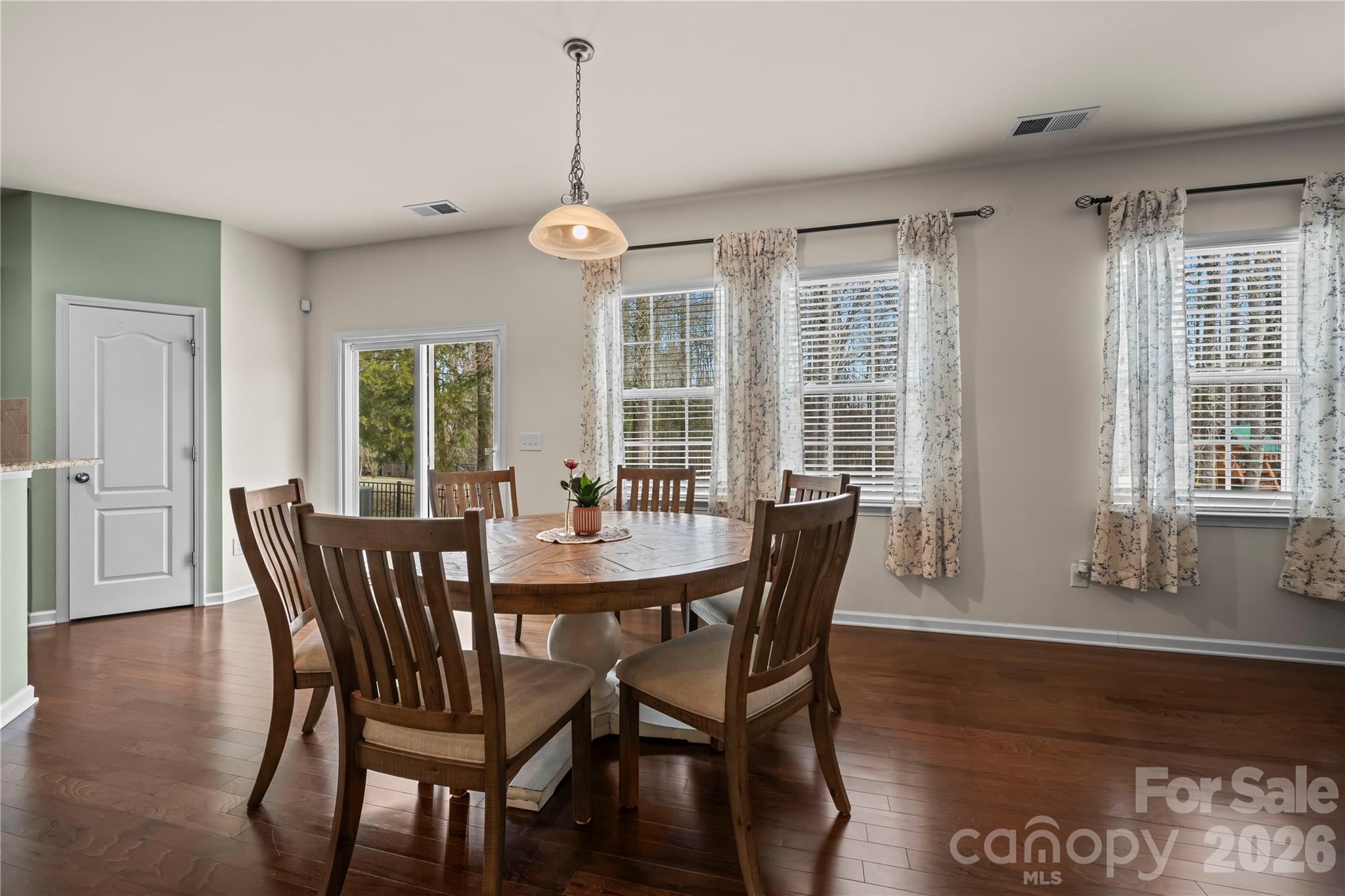 10666 Sapphire Trail Davidson, NC 28036 - Photo 13 of 34 a view of a dining room with furniture window and wooden floor