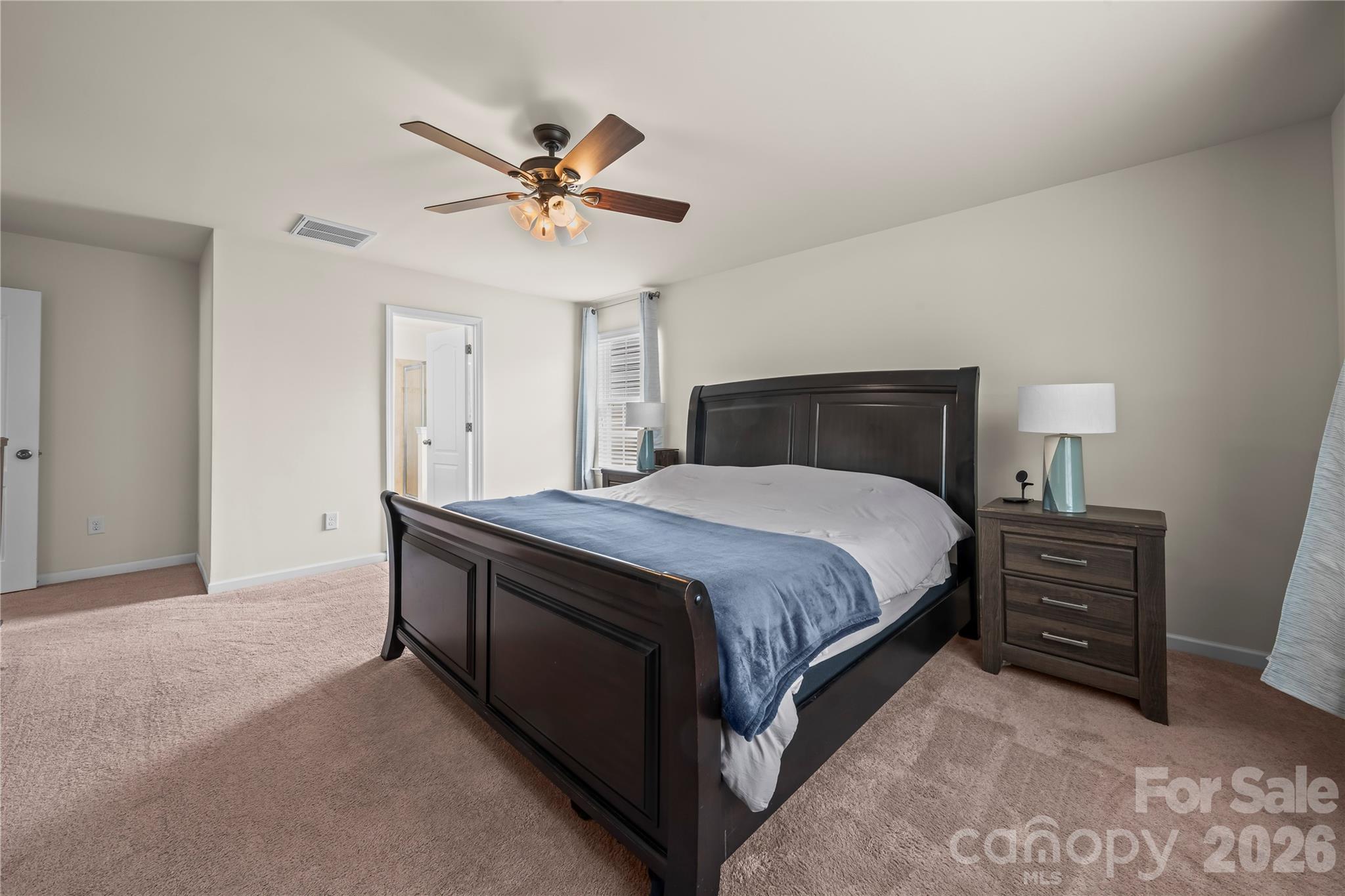 10666 Sapphire Trail Davidson, NC 28036 - Photo 17 of 34 a spacious bedroom with a bed and a chandelier