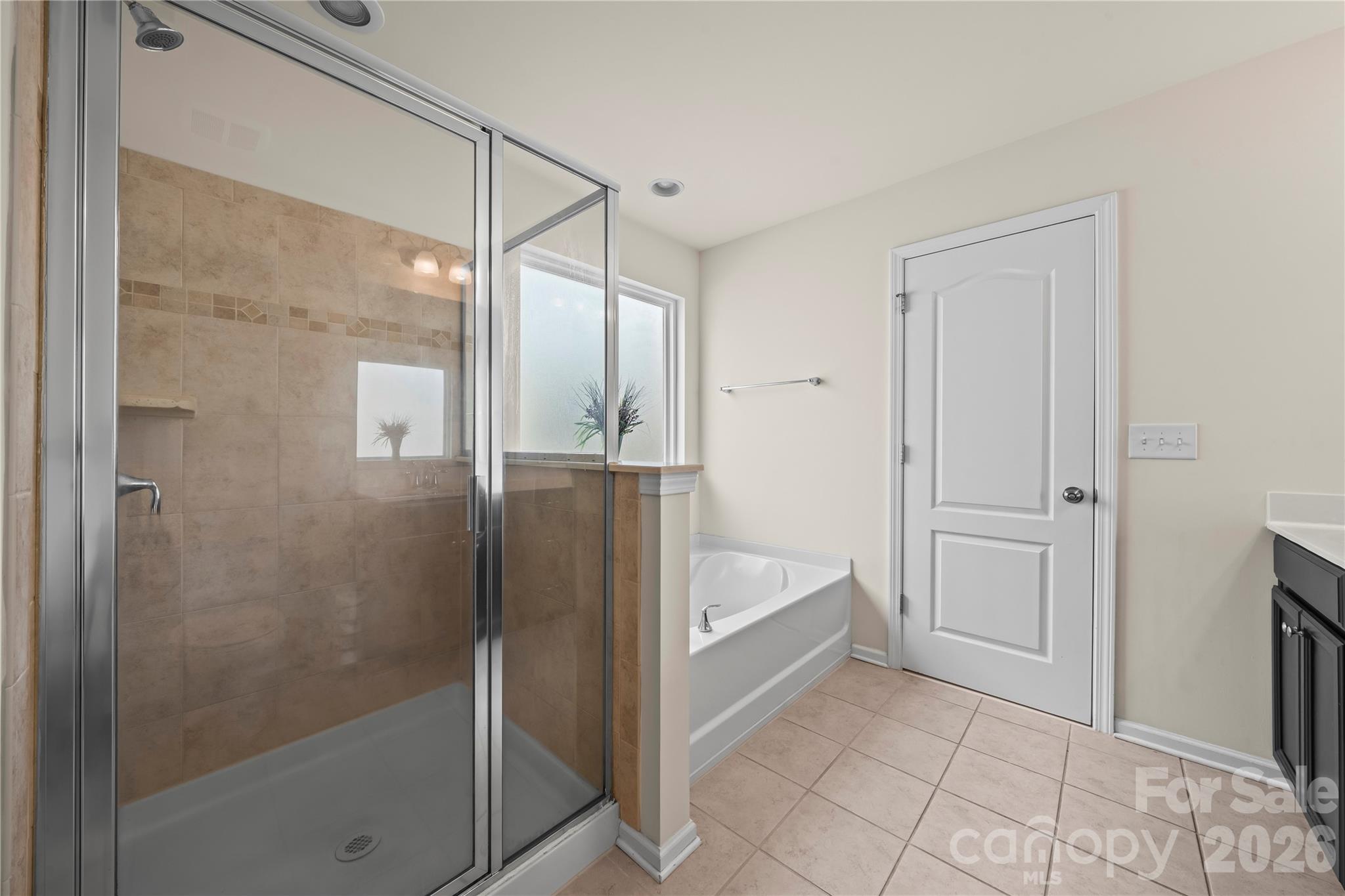 10666 Sapphire Trail Davidson, NC 28036 - Photo 20 of 34 a bathroom with a tub and shower