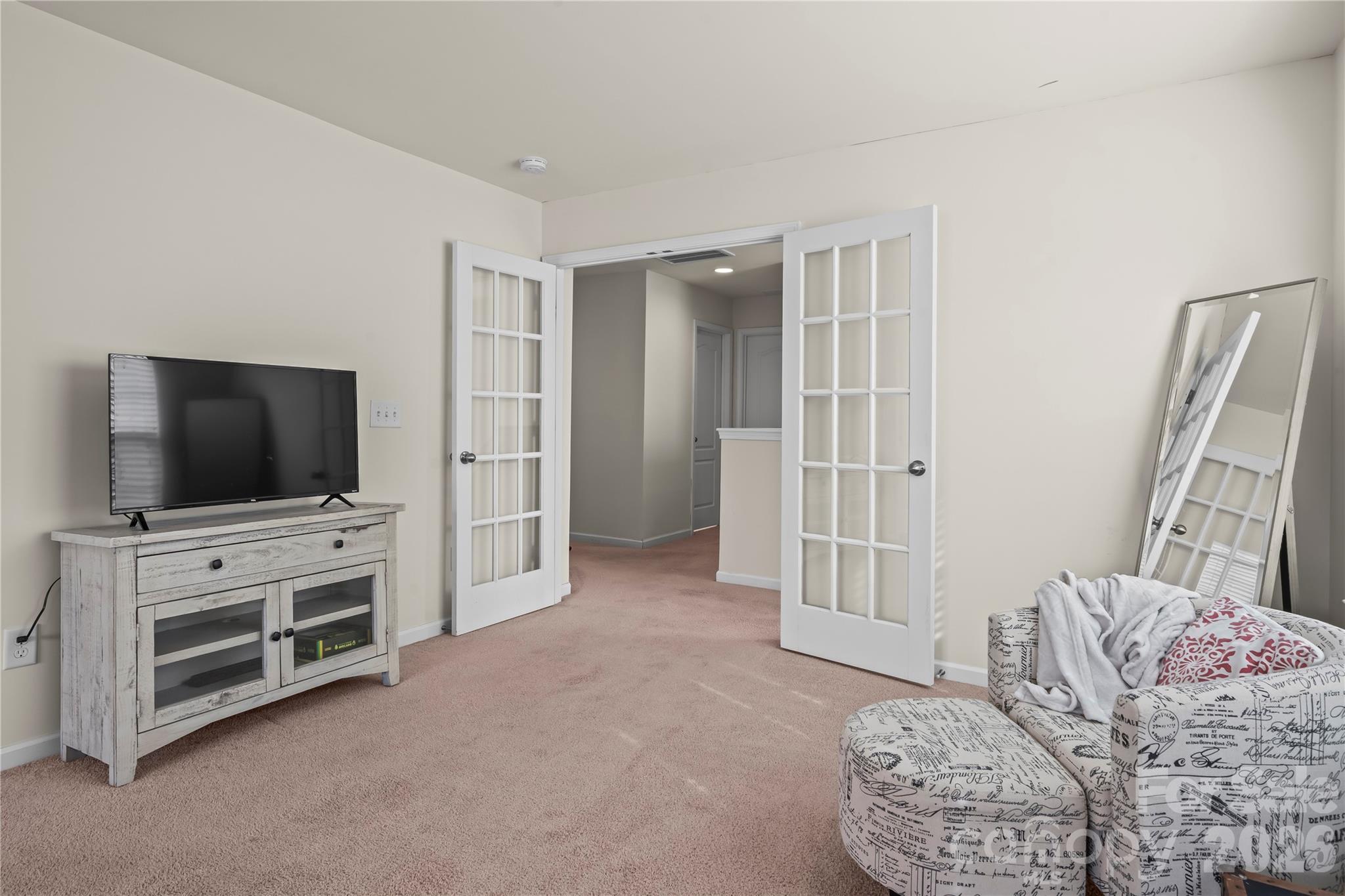 10666 Sapphire Trail Davidson, NC 28036 - Photo 22 of 34 a living room with furniture and a flat screen tv